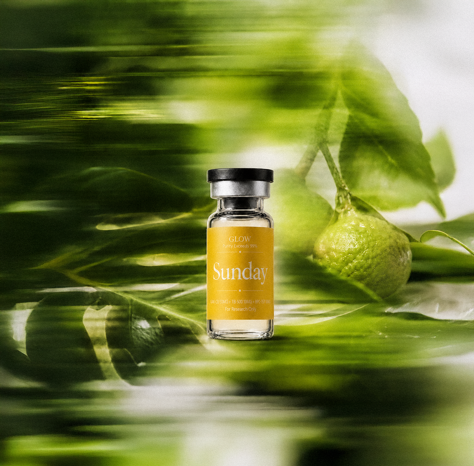 Sunday GLOW research vial among green leaves and citrus