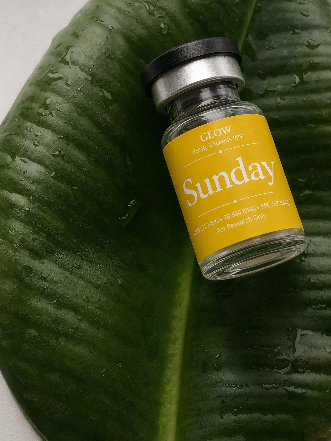 Sunday GLOW vial resting on a green leaf.